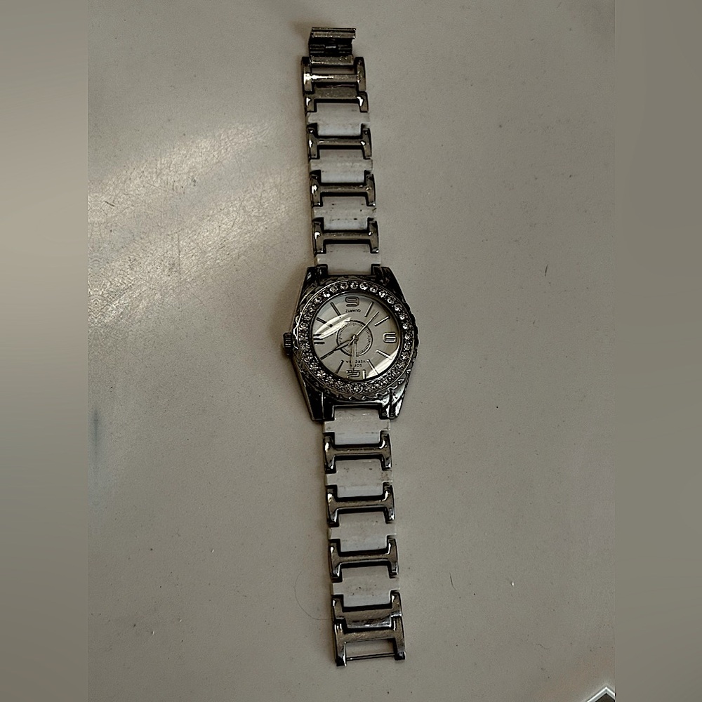 Sofia Vagara , analog, white and silver wristwatch w/ diamonds